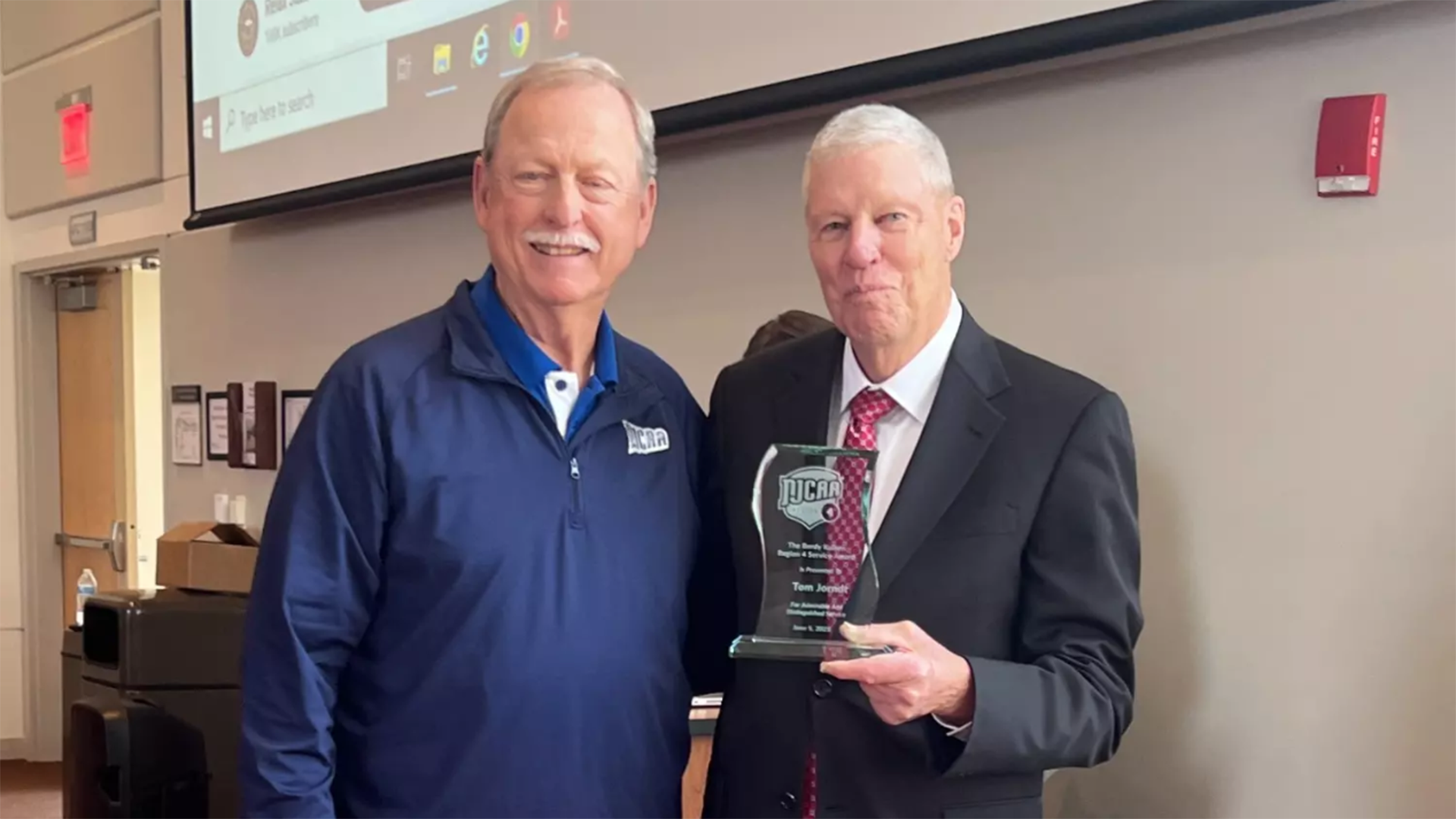 Wally Reynolds, National Junior College Athletic Association (NJCAA) Region 4 Men's assistant director, with Tom Jorndt, former Oakton College Athletics director and coach at Waubonsee Community College, June 5.